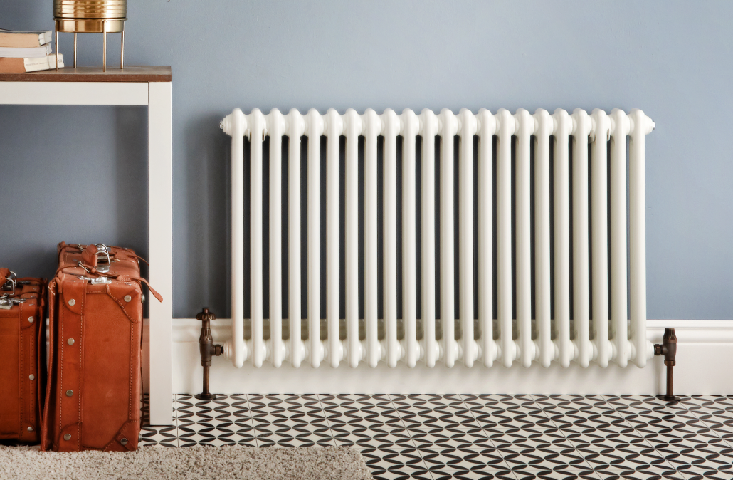 The White Milano Windsor Column Radiatorr in a blue hallway The White Milano Windsor Column Radiator